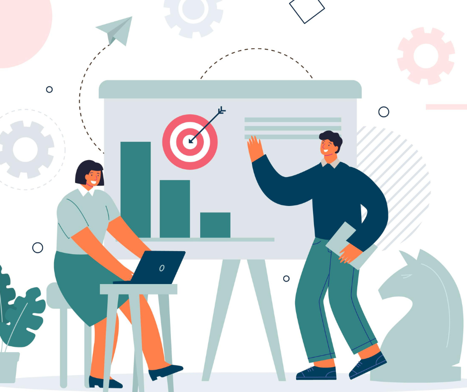 Une femme travaille sur un ordinateur pendant qu'un homme présente une stratégie.